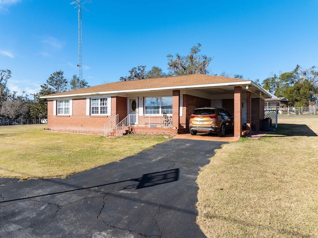 ranch-style home with a front yard and a carport