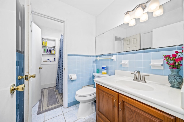 bathroom with tile patterned flooring, vanity, toilet, and tile walls