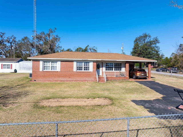 ranch-style home featuring a carport and a front lawn