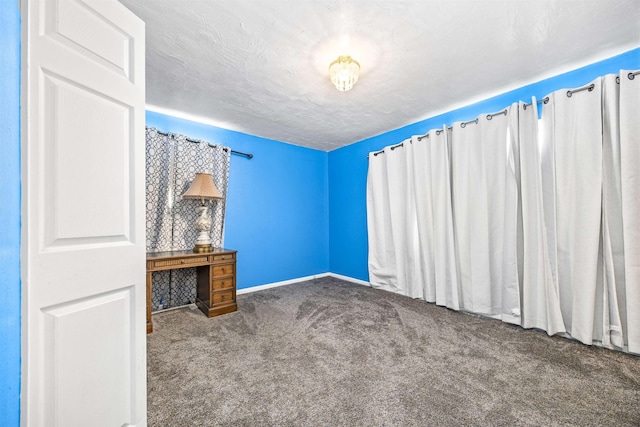 interior space featuring carpet flooring and a textured ceiling