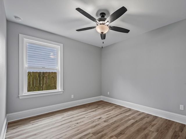 spare room with ceiling fan and light wood-type flooring