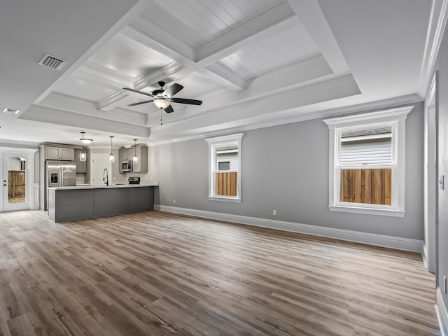 unfurnished living room featuring coffered ceiling, crown molding, wood-type flooring, and beam ceiling