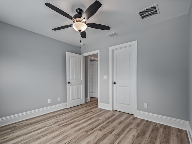 unfurnished bedroom with ceiling fan and light wood-type flooring