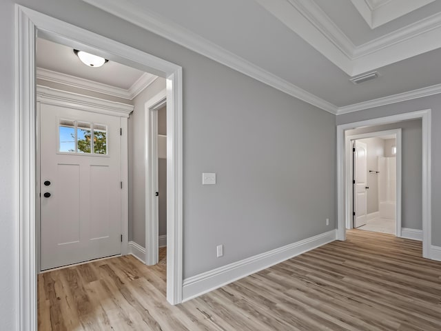 entryway featuring crown molding and light hardwood / wood-style flooring