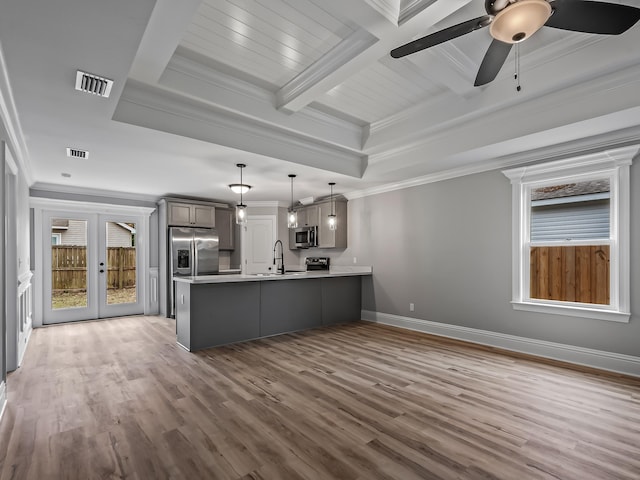 unfurnished living room with french doors, ornamental molding, sink, and wood-type flooring