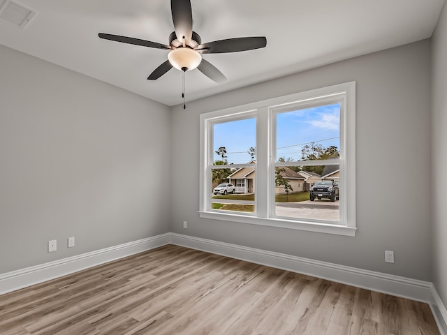 empty room with light hardwood / wood-style floors and ceiling fan