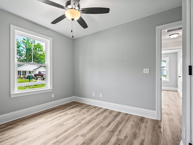 67 Broken Bow Trl, Crawfordville, FL 32327 - empty room featuring light wood-type flooring, healthy amount of natural light, and baseboards