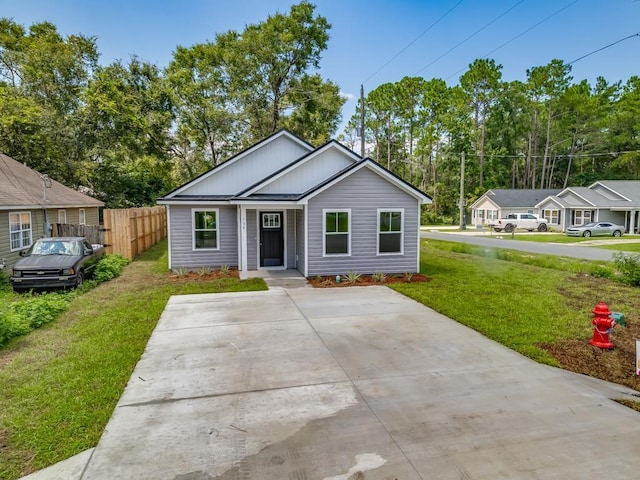 67 Broken Bow Trl, Crawfordville, FL 32327 - view of front of home with board and batten siding and view of wooded area
