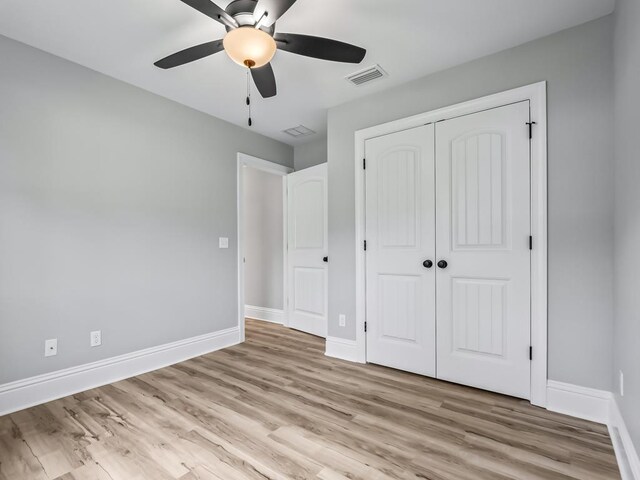 67 Broken Bow Trl, Crawfordville, FL 32327 - unfurnished bedroom featuring light wood finished floors, a closet, and baseboards