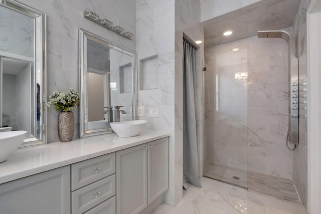 bathroom featuring vanity, tile walls, and a tile shower