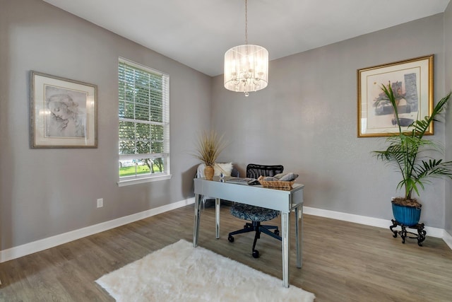 office with hardwood / wood-style flooring and a chandelier