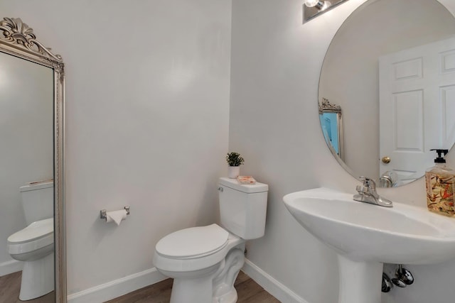 bathroom featuring hardwood / wood-style flooring, sink, and toilet