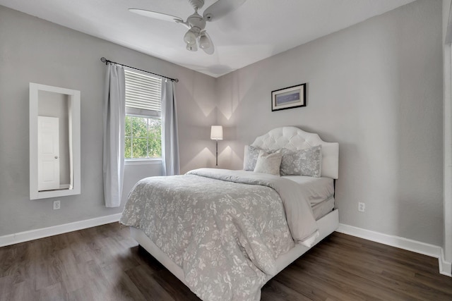 bedroom with dark hardwood / wood-style flooring and ceiling fan