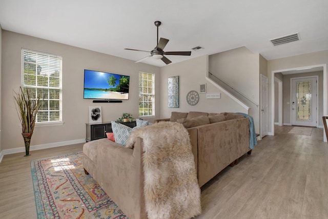 living room with ceiling fan and light hardwood / wood-style floors