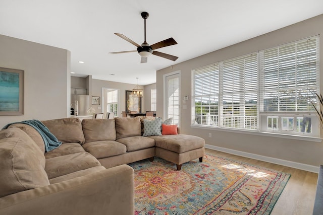 living room with ceiling fan and hardwood / wood-style floors