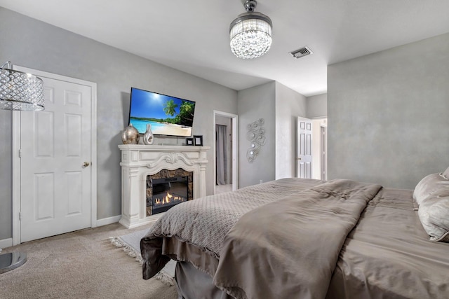 carpeted bedroom with a notable chandelier