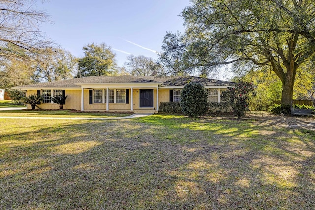 ranch-style house with a front lawn and brick siding