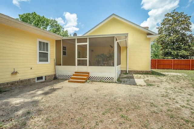 back of property featuring a sunroom