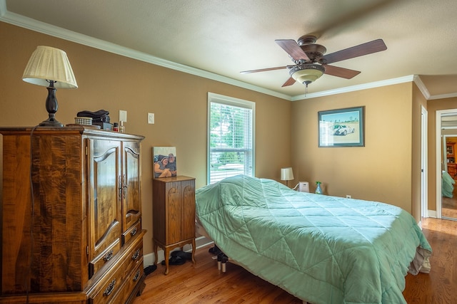 bedroom with ceiling fan, crown molding, and light hardwood / wood-style floors