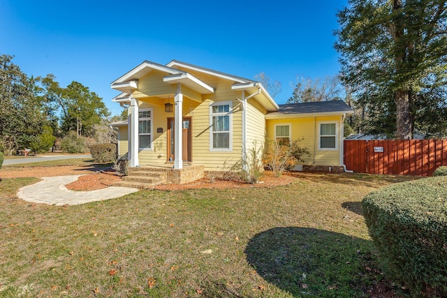 bungalow-style house with a front lawn