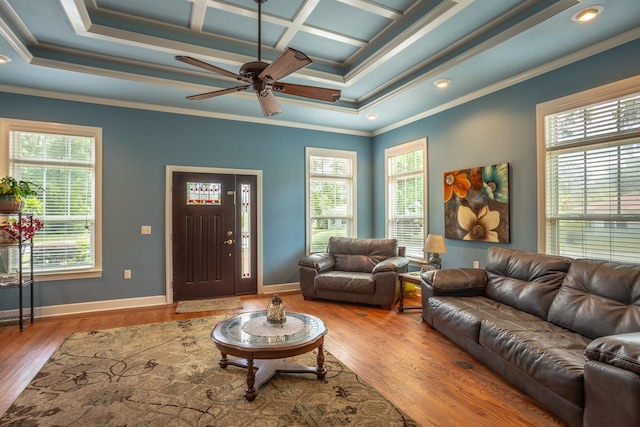 living room featuring a wealth of natural light, crown molding, wood-type flooring, and coffered ceiling