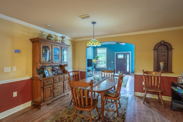 dining room featuring hardwood / wood-style flooring, ceiling fan, and crown molding