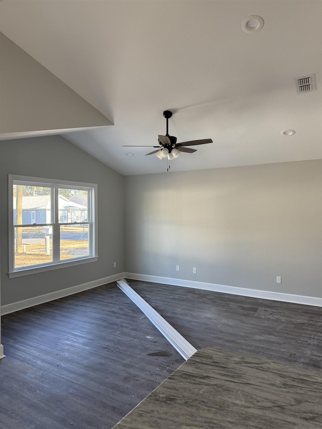 spare room featuring ceiling fan, lofted ceiling, and dark hardwood / wood-style floors