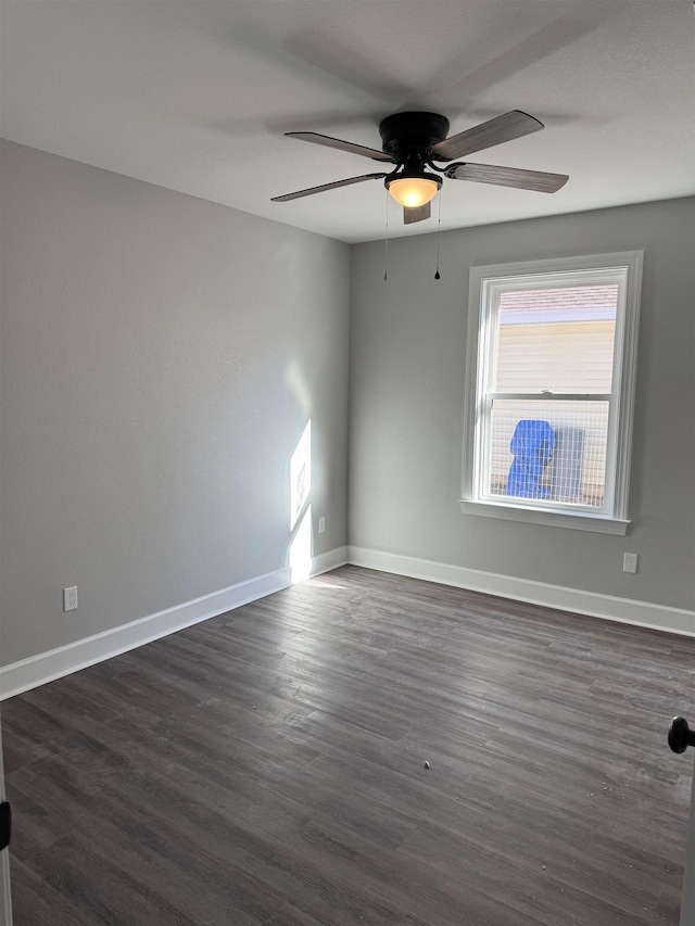 empty room featuring ceiling fan and dark hardwood / wood-style flooring