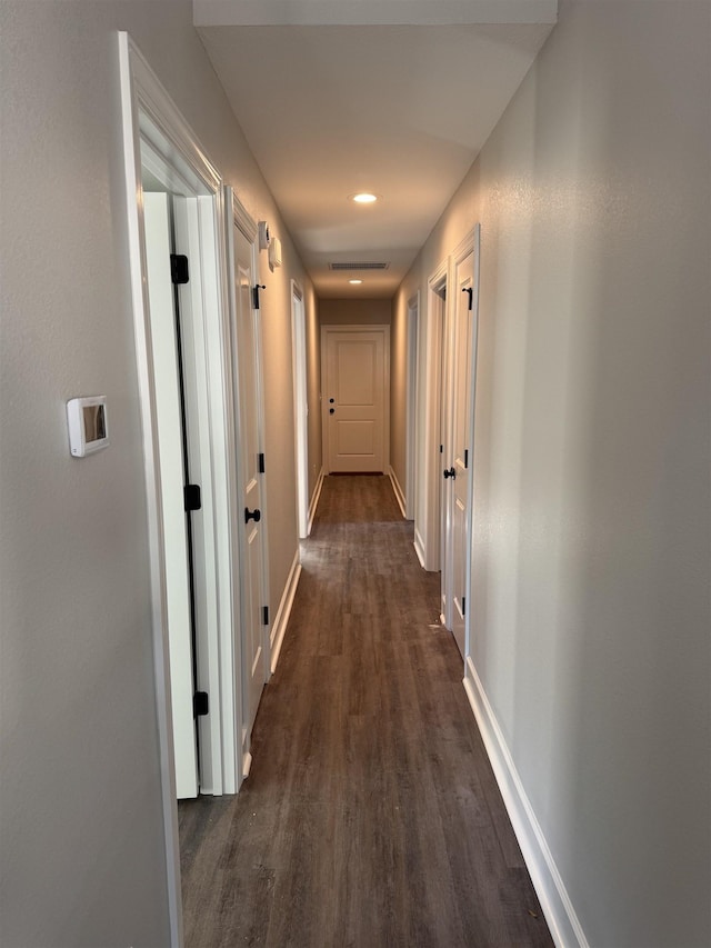 corridor with dark hardwood / wood-style floors