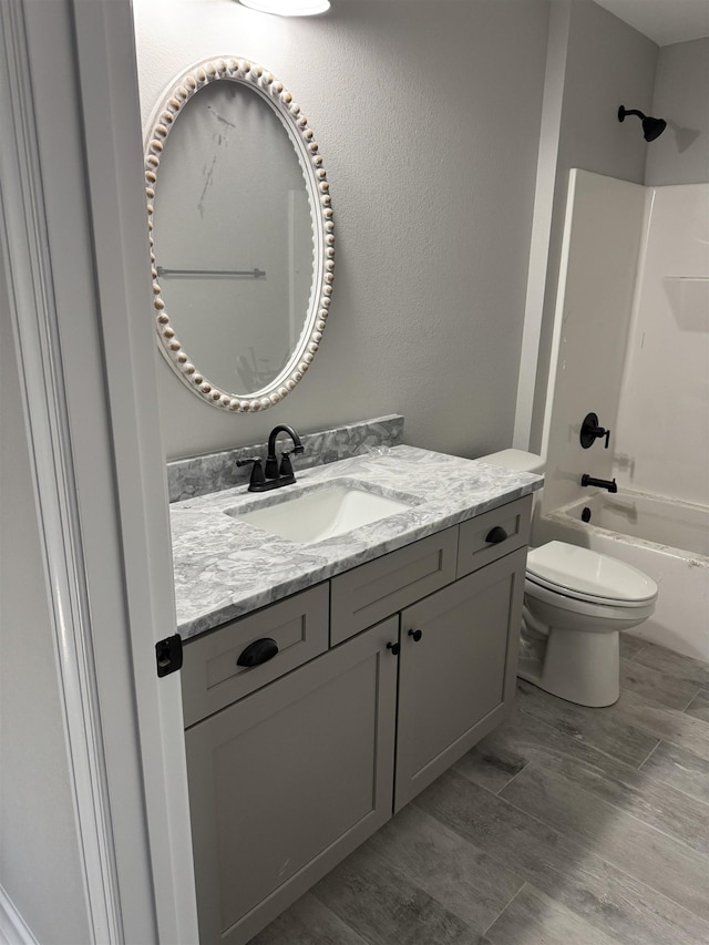 full bathroom featuring toilet, vanity, shower / tub combination, and hardwood / wood-style flooring