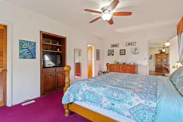 carpeted bedroom with ceiling fan, a textured ceiling, visible vents, and crown molding