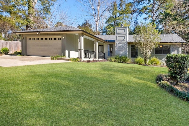 view of front of house with covered porch, a front lawn, and a garage