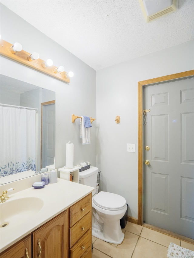 181 NE Biltmore Rd, Madison, FL 32340 - full bath featuring tile patterned floors, vanity, toilet, and a textured ceiling
