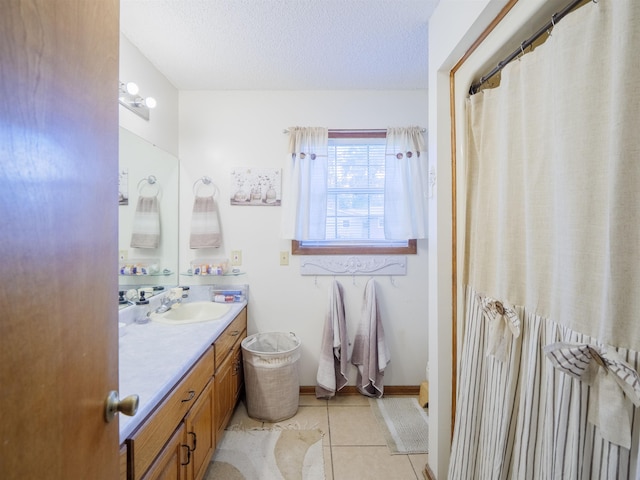 181 NE Biltmore Rd, Madison, FL 32340 - bathroom featuring vanity, tile patterned floors, and a textured ceiling