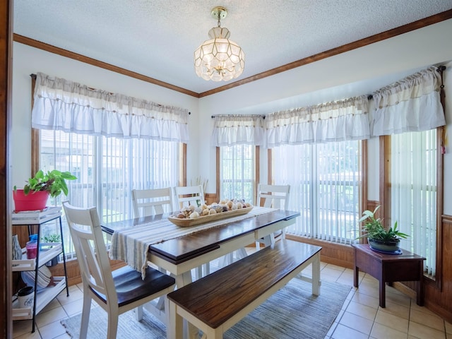 181 NE Biltmore Rd, Madison, FL 32340 - dining area with ornamental molding, healthy amount of natural light, a chandelier, a textured ceiling, and light tile patterned floors