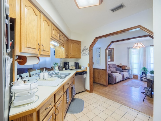 181 NE Biltmore Rd, Madison, FL 32340 - kitchen with dishwasher, light countertops, a sink, and light tile patterned flooring
