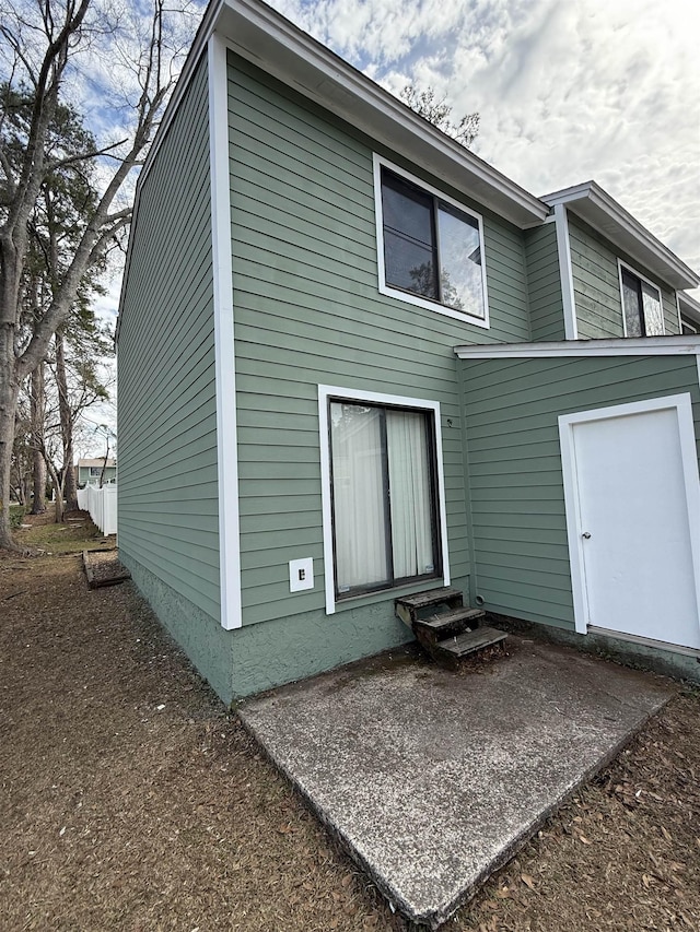 back of property featuring a patio