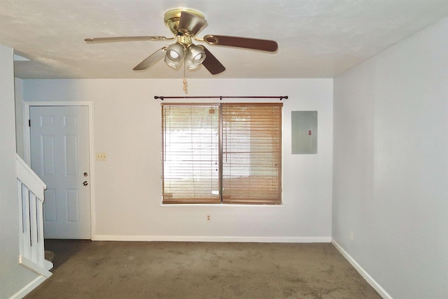 carpeted empty room featuring electric panel and ceiling fan