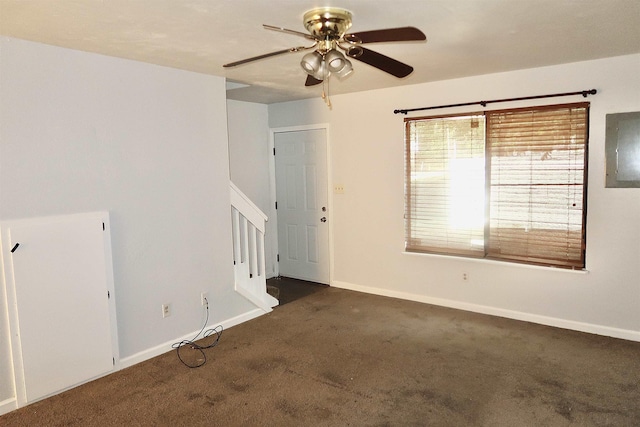 carpeted spare room featuring ceiling fan