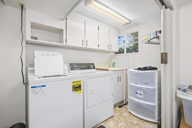 laundry area featuring cabinet space and washing machine and clothes dryer