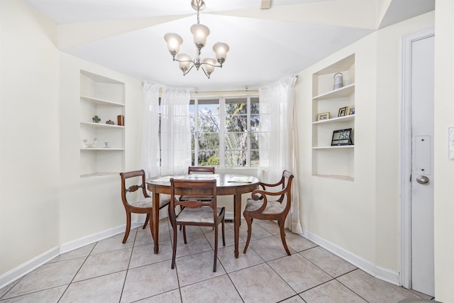 dining room featuring built in features, a notable chandelier, baseboards, and light tile patterned floors