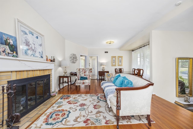 living room featuring a fireplace and wood finished floors