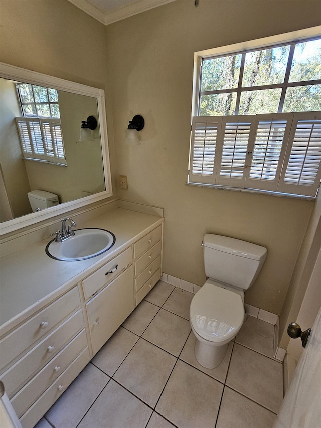 bathroom featuring a wealth of natural light, tile patterned flooring, vanity, and toilet