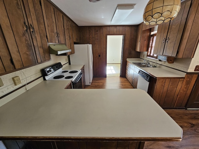 kitchen with white appliances, light countertops, a sink, and under cabinet range hood