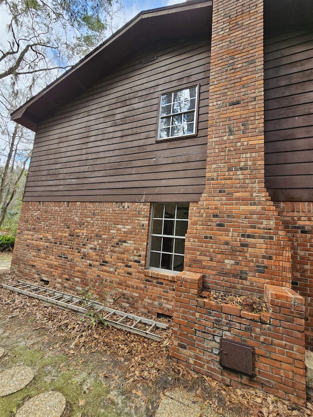 view of home's exterior with brick siding