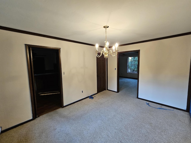 empty room featuring ornamental molding, light colored carpet, a notable chandelier, and baseboards