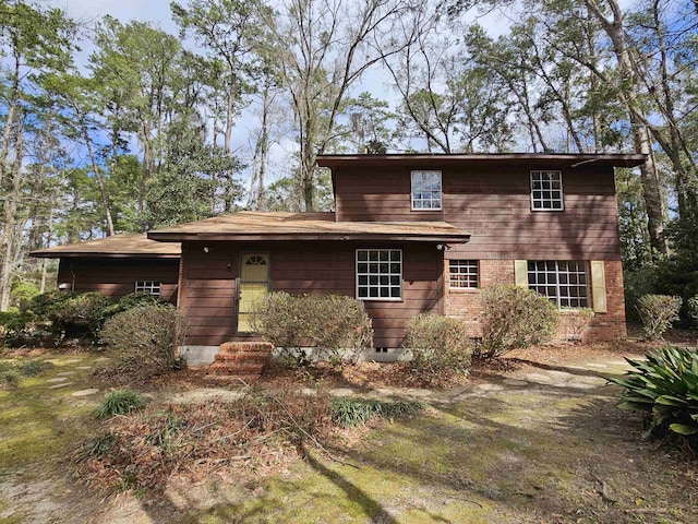 view of front facade featuring crawl space and brick siding