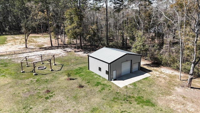 drone / aerial view featuring a wooded view