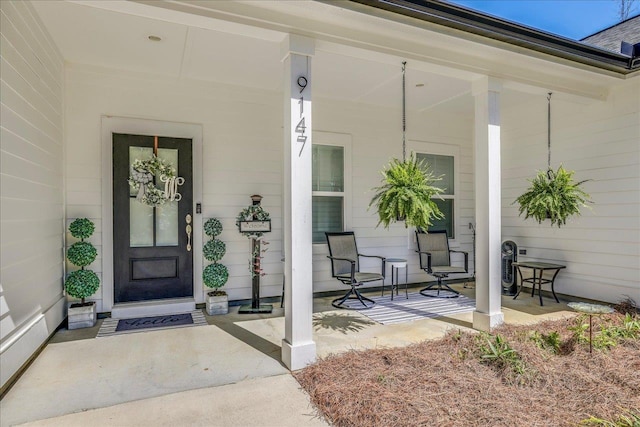 doorway to property featuring covered porch