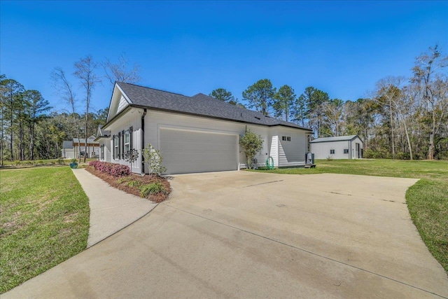 view of property exterior with a garage, a lawn, roof with shingles, and concrete driveway